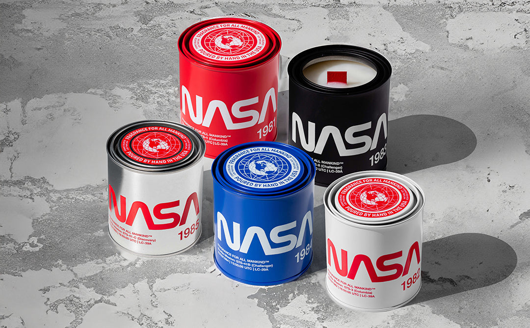 NASA Candle Collection – six limited-edition soy candles inspired by historic space missions, featuring stainless steel canisters and bold NASA designs