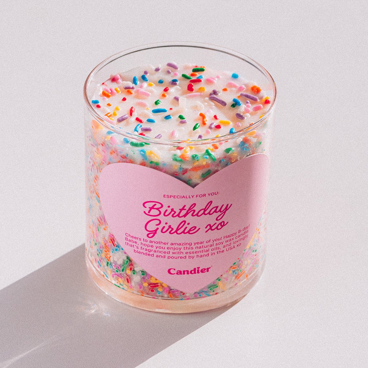 Candier birthday cake candle with cute pink aesthetic heart shaped label and gourmand scent