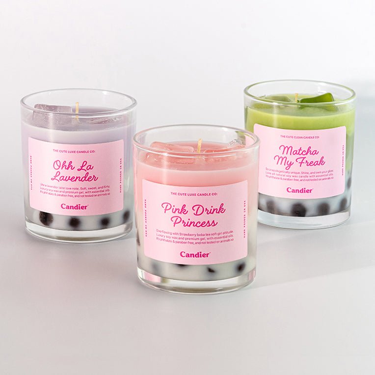 Three boba candles with pink labels on a white background inspired by real matcha latte and bubble tea dessert drinks