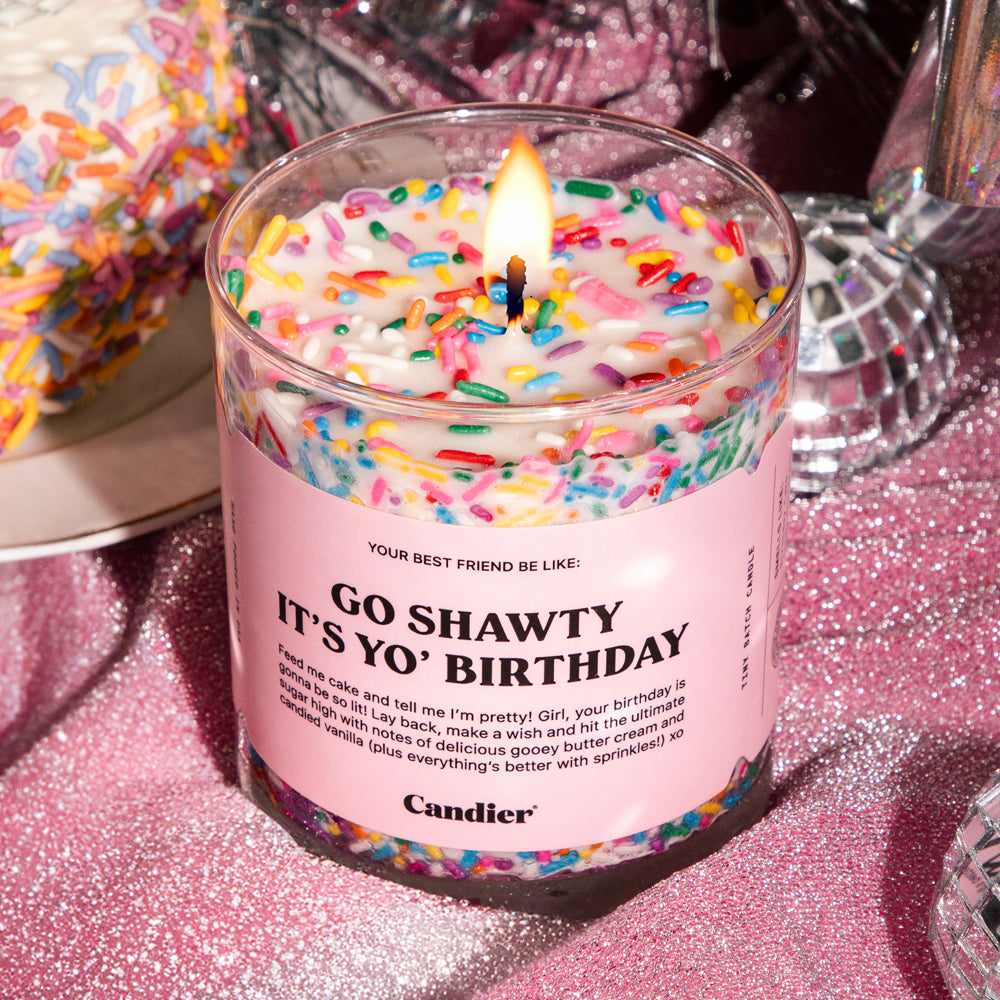 A birthday cake themed scented candle with colorful sprinkles