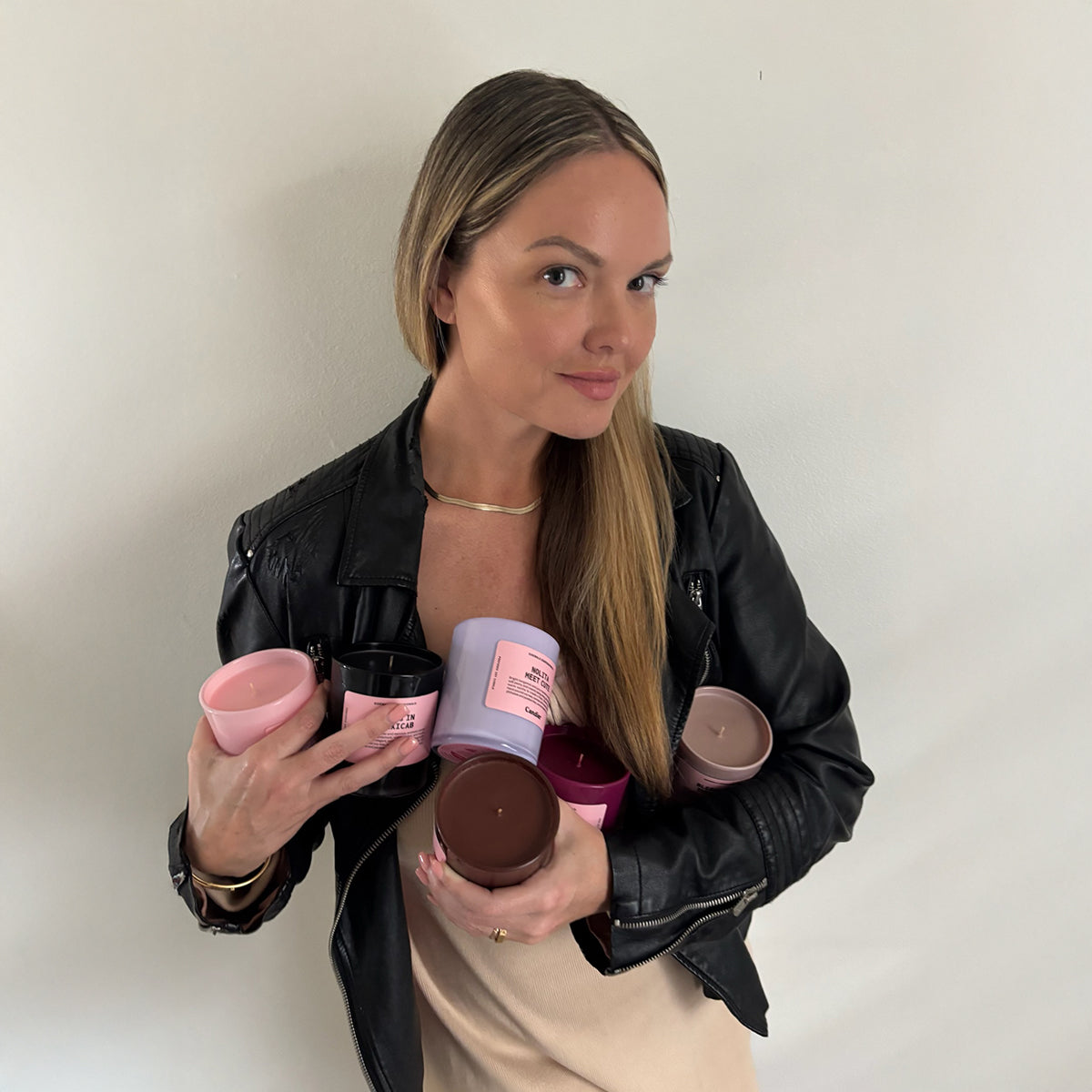 Candier's founder holding the New York candle collection