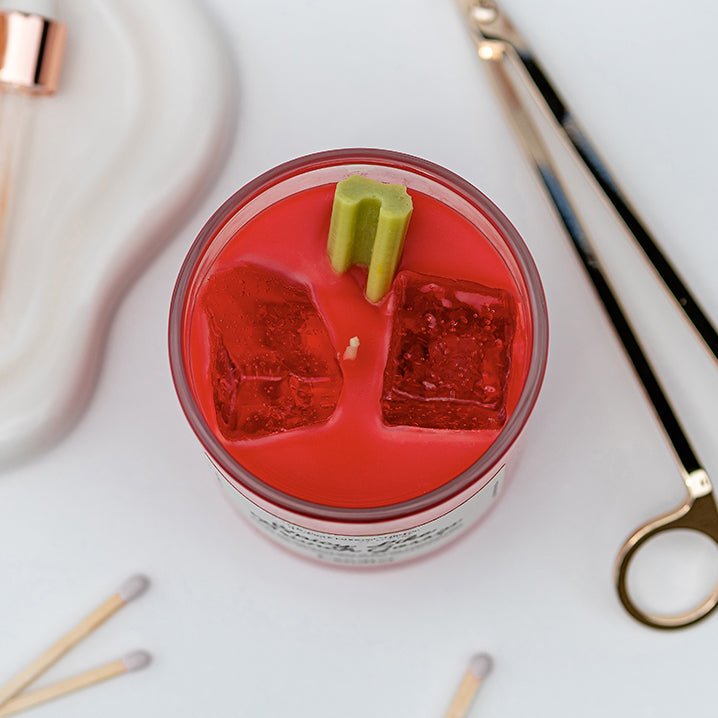 Overhead view of Candier tomato leaf candle with Bloody Mary scent, realistic gel ice cubes, and soy celery garnish. Great gift for tomato girls
