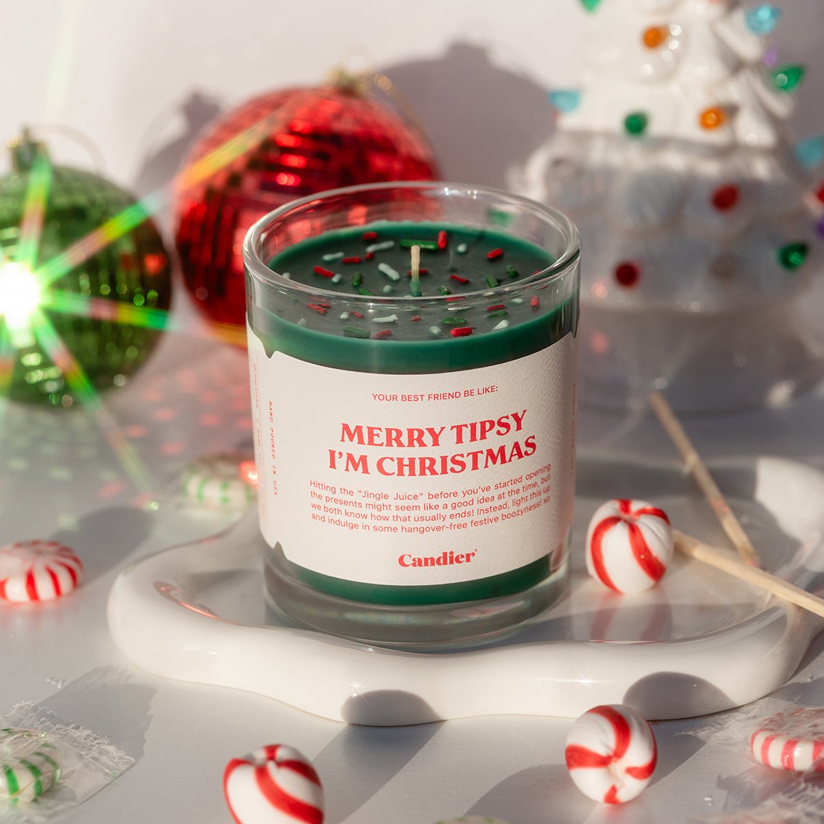 Flatlay of Candier apple cinnamon funny candle — cute Christmas candles and sweet Christmas gifts for sisters; also a best Secret Santa gifts pick.