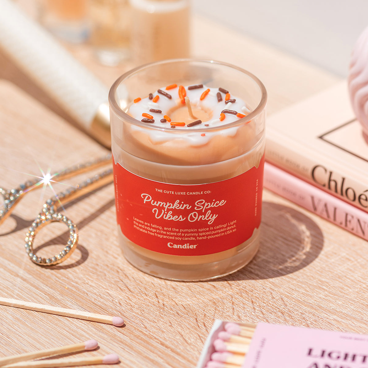 Sweet scented pumpkin candle by Candier with wax donut and sprinkles, candycore bakery candle for cozy fall vibes.