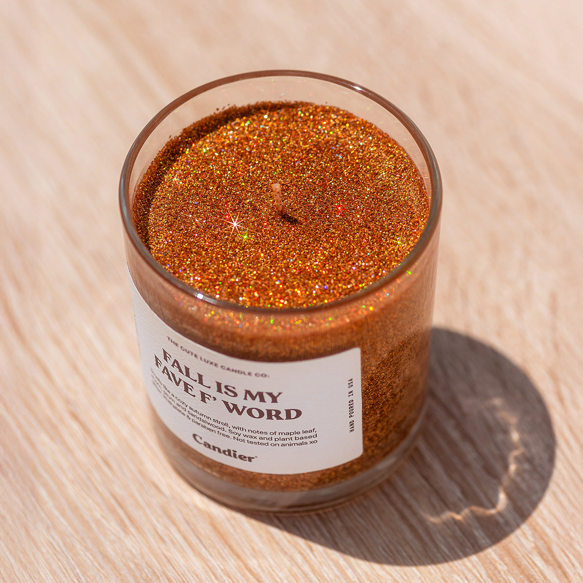 Candier candles Fall Is My Fave F Word, a cozy cashmere candle with plant-based glitter and luxe autumn fragrance.