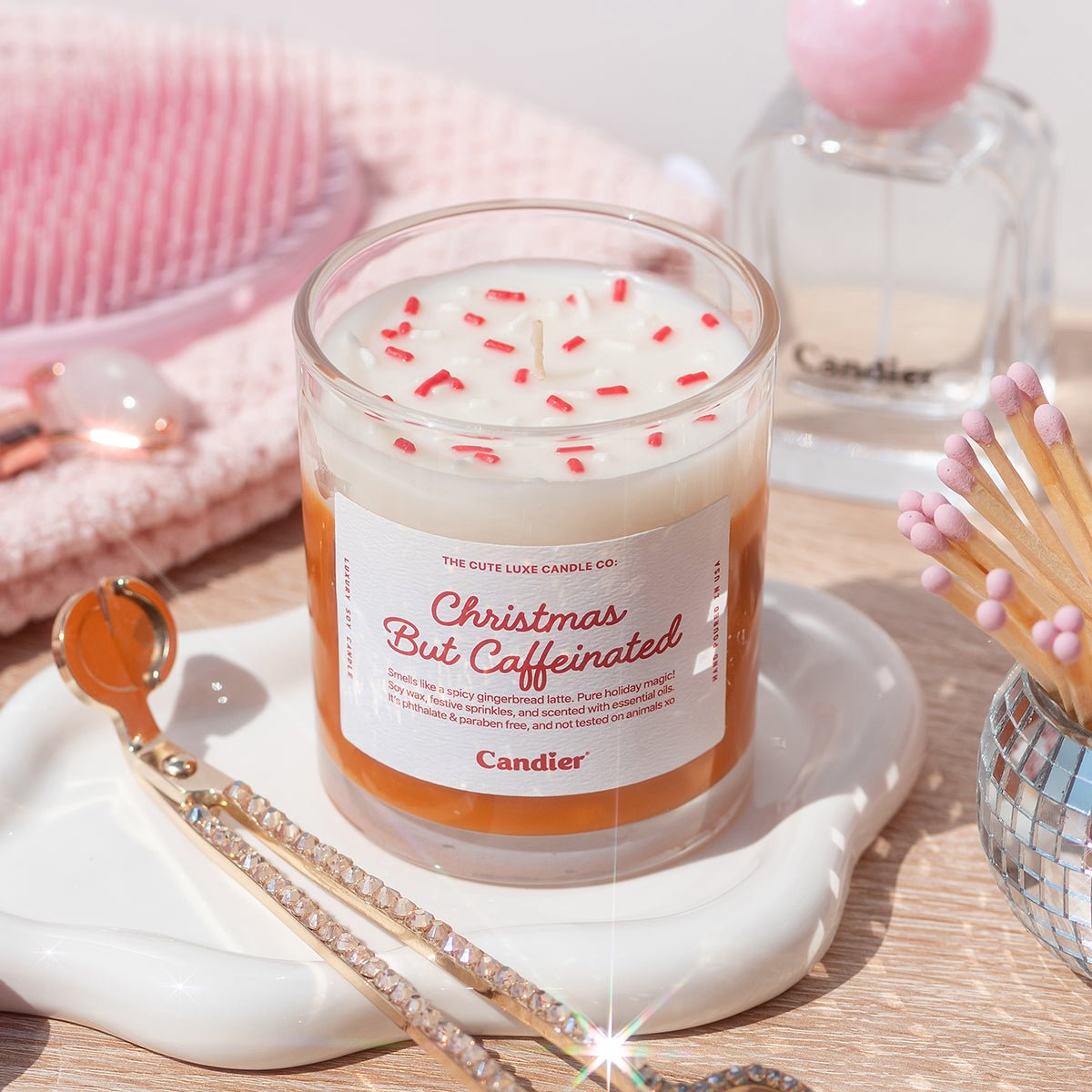 Flatlay of Christmas But Caffeinated Candle — creamy gingerbread latte soy wax candle with Christmas sprinkles, perfect secret Santa gift for her.