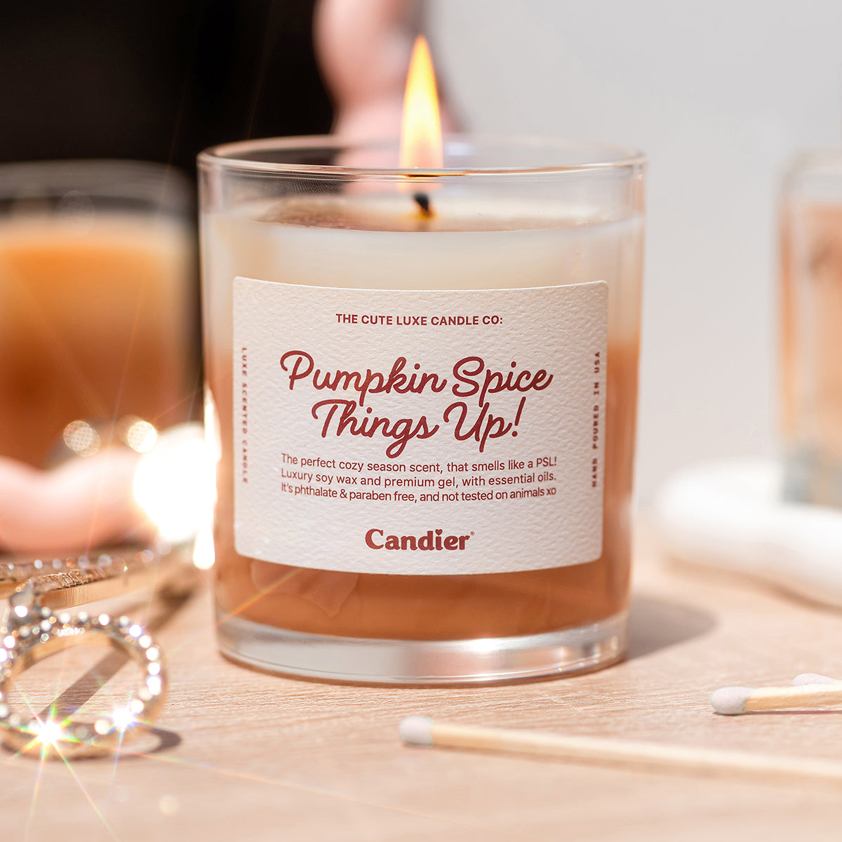 Candier pumpkin spice latte candle burning, cozy candles for fall with sweet dessert fragrance and soft girl aesthetic.