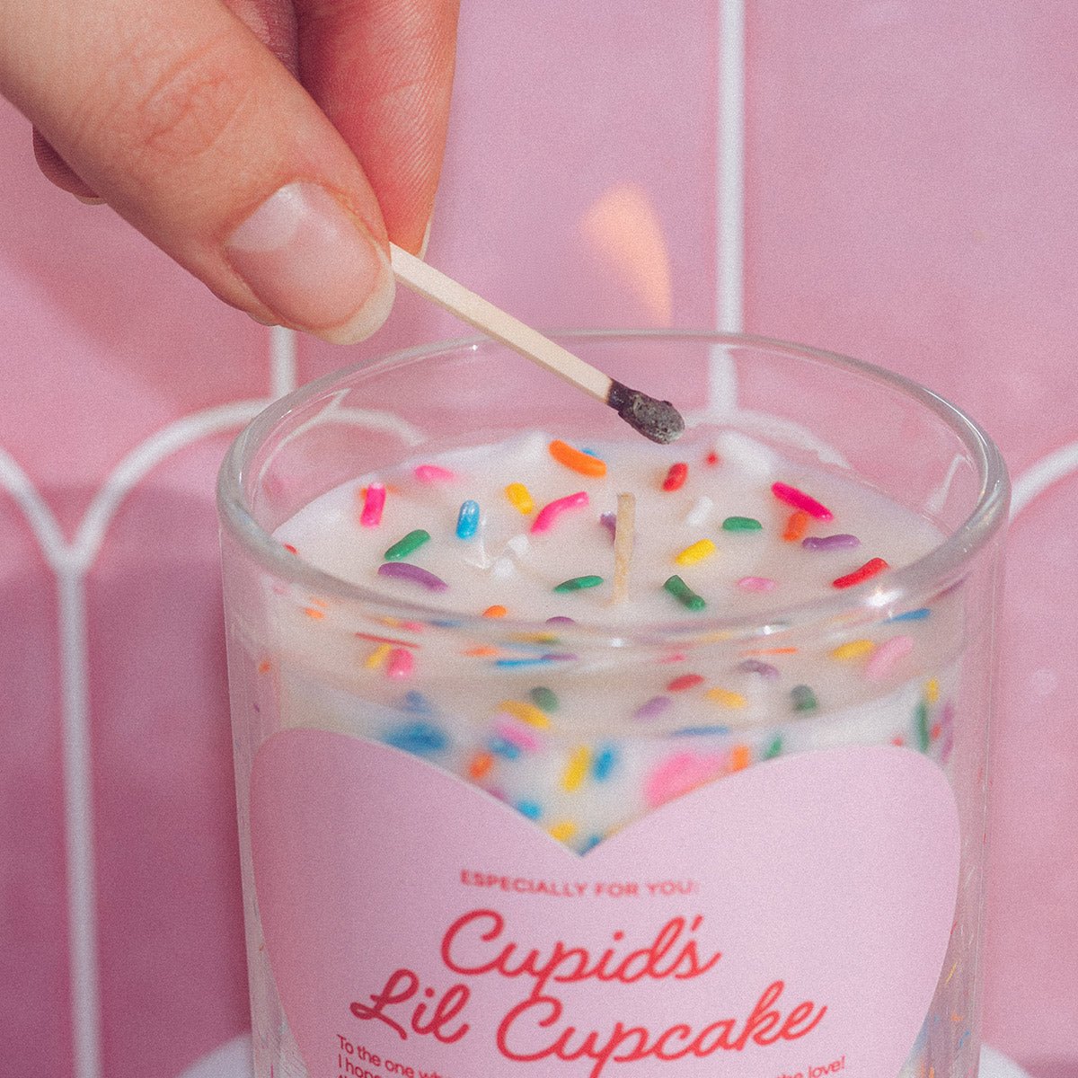Close-up of Candier Cupid’s Lil Cupcake sprinkle candle being finished, a handcrafted vanilla Valentine candle made with clean soy wax