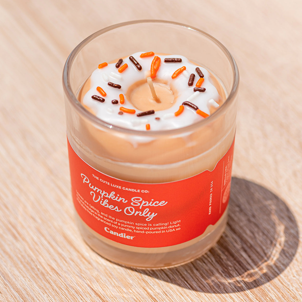 Cute aesthetic Candier pumpkin spice candle styled with beauty products, luxe dessert candle for cute room decor and girly gift baskets