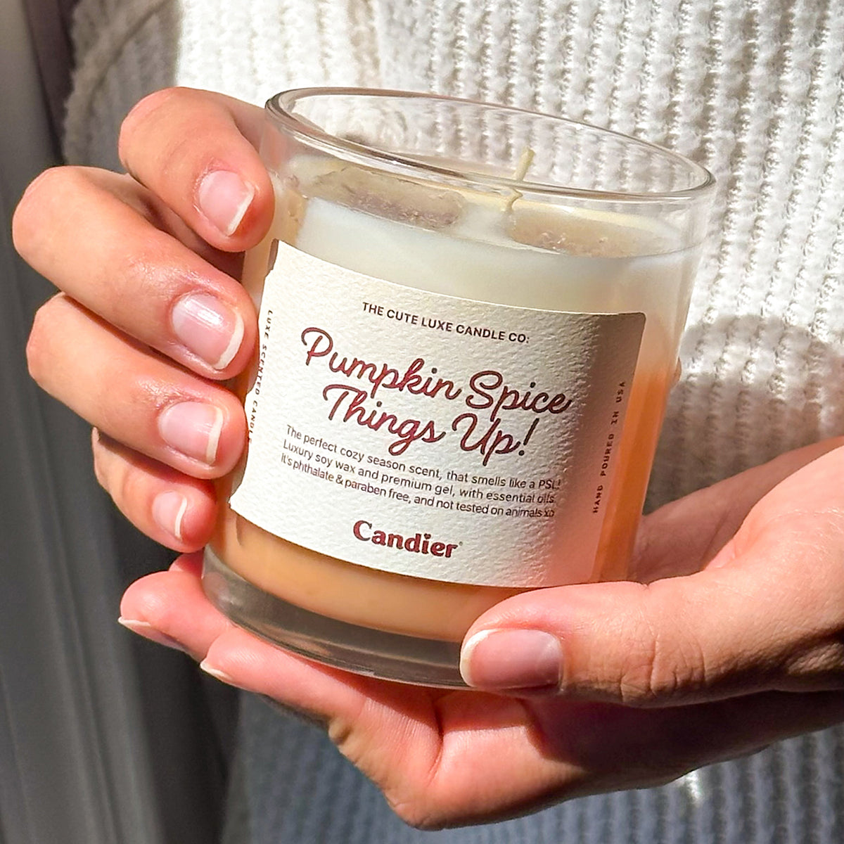 Cute Candier pumpkin spice latte candle in hand, cozy candles for fall and luxe dessert candle gift idea for friends and teen girls.