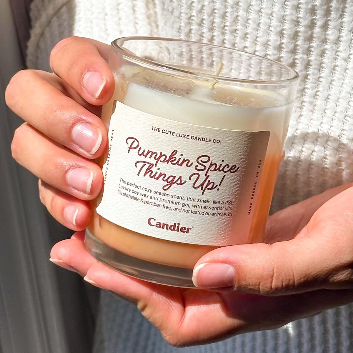 Cute Candier pumpkin spice latte candle in hand, cozy candles for fall and luxe dessert candle gift idea for friends and teen girls.