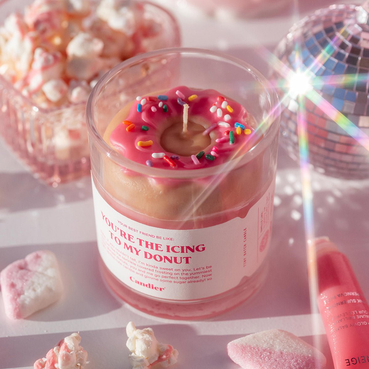 Styled Valentine’s Day dessert candle from Candier featuring a strawberry donut wax topper with sprinkles, romantic pink tones, and luxury gift aesthetic