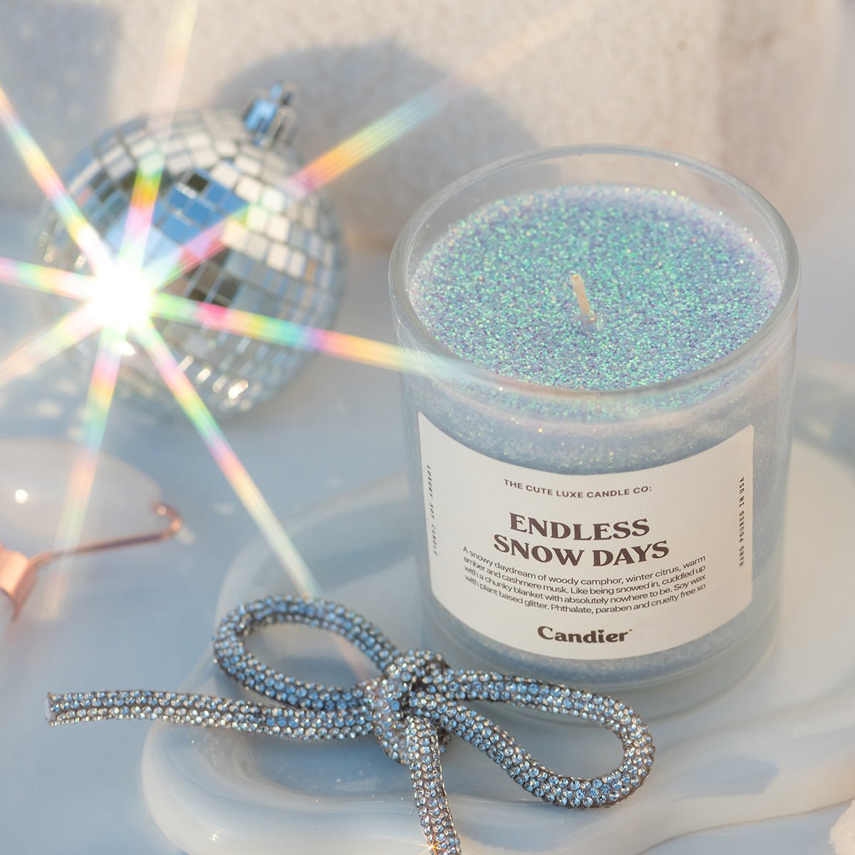 Ribboned flatlay of Endless Snow Days—cute candles for christmas gifts for sisters and friends; soft girl aesthetic cute room decor; elegant Hanukkah gifts.
