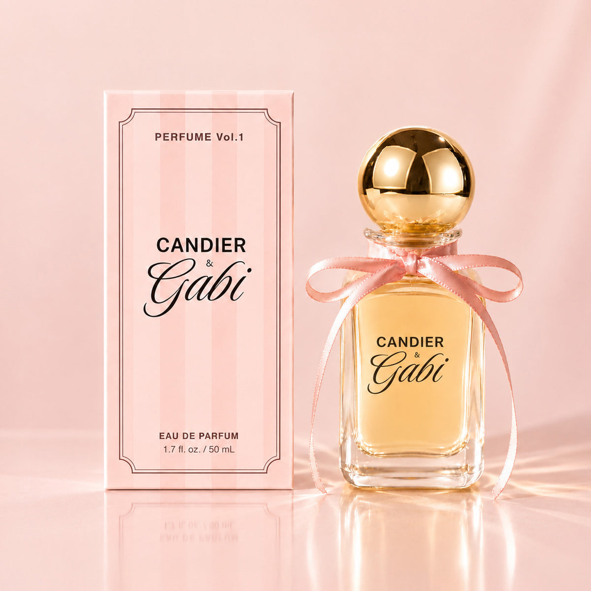 Candier x Gabi Pink Air eau de parfum bottle with a gold cap and pink bow beside its pink striped carton.