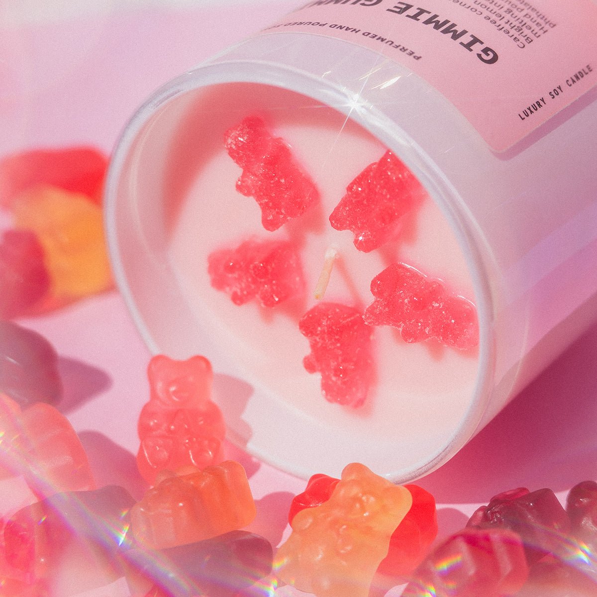 Top view of Candier Gimmie Gummies pink candle with gummy bear wax embeds, a dessert candle with cute aesthetic appeal for cute room decor