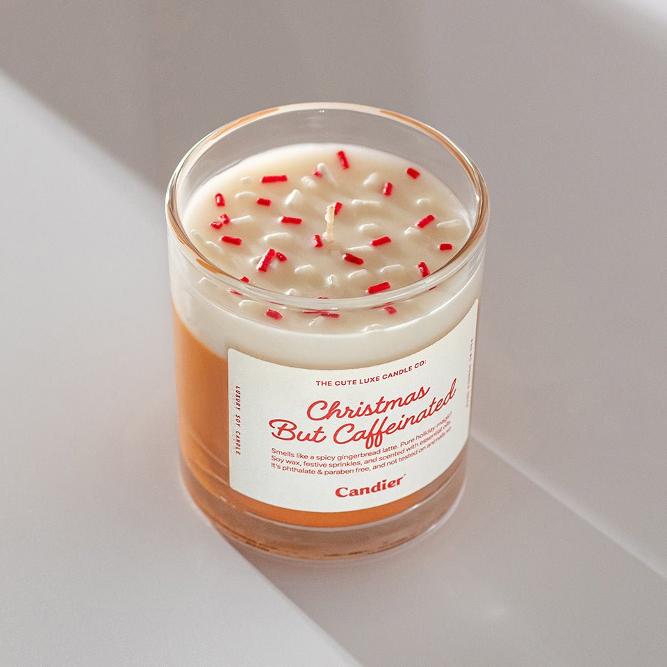 Top view of Candier Christmas But Caffeinated Candle — sweet coffee-scented candle with red holiday sprinkles, cute and cozy Christmas gift for her.