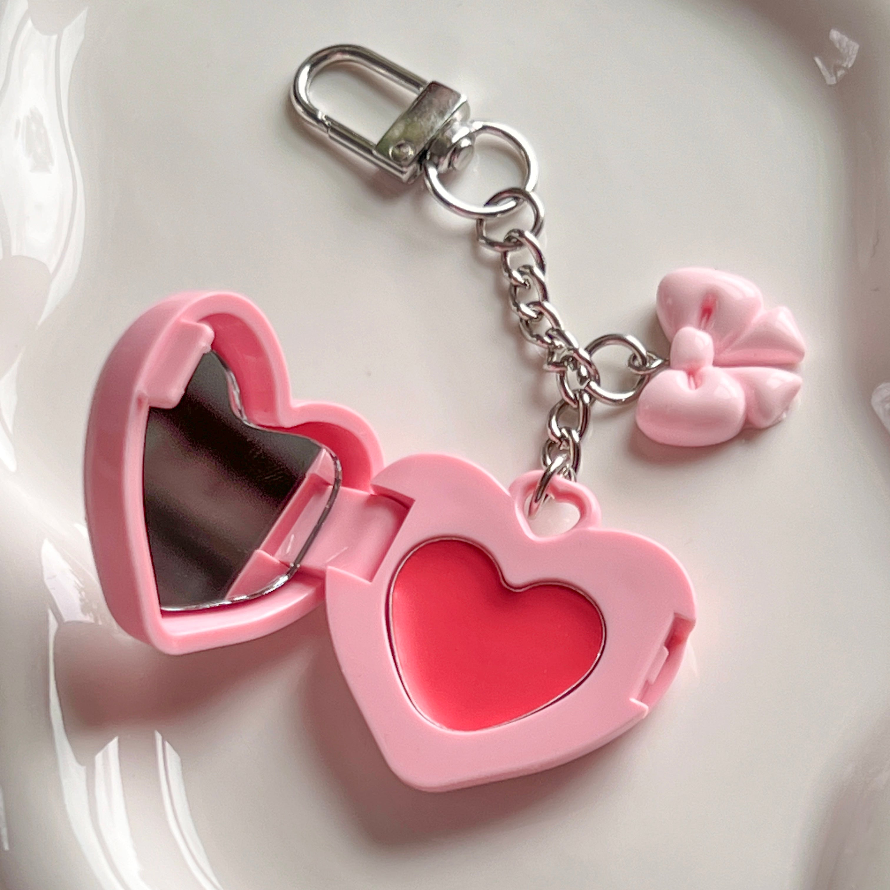 Open pink lip balm keychain showing tinted balm and mirror – best tinted lip balm with 90's aesthetic and coquette bow