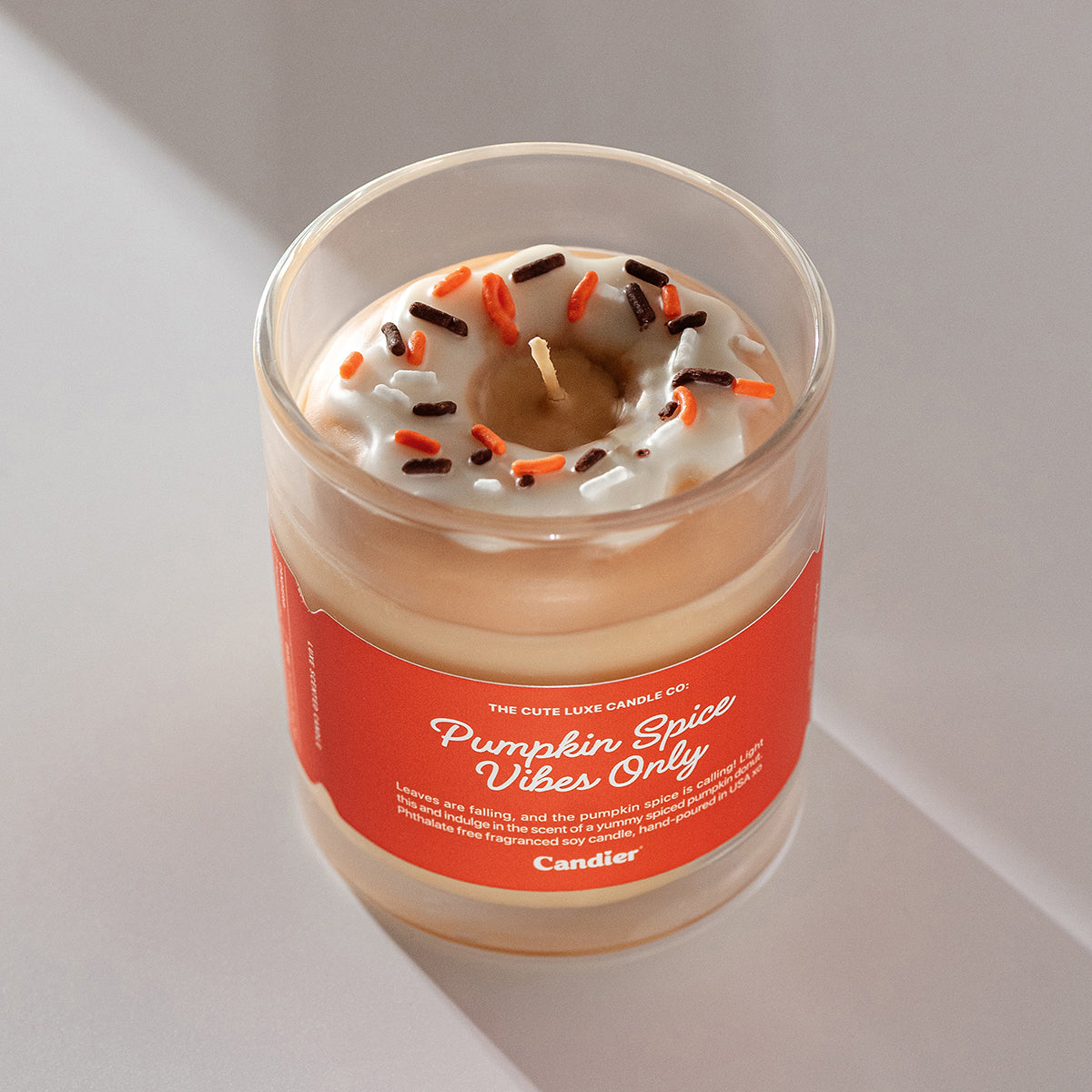 Pretty pumpkin spice candle by Candier, food scented candle with sprinkles donut design, perfect cute room decor and soft girl aesthetic.