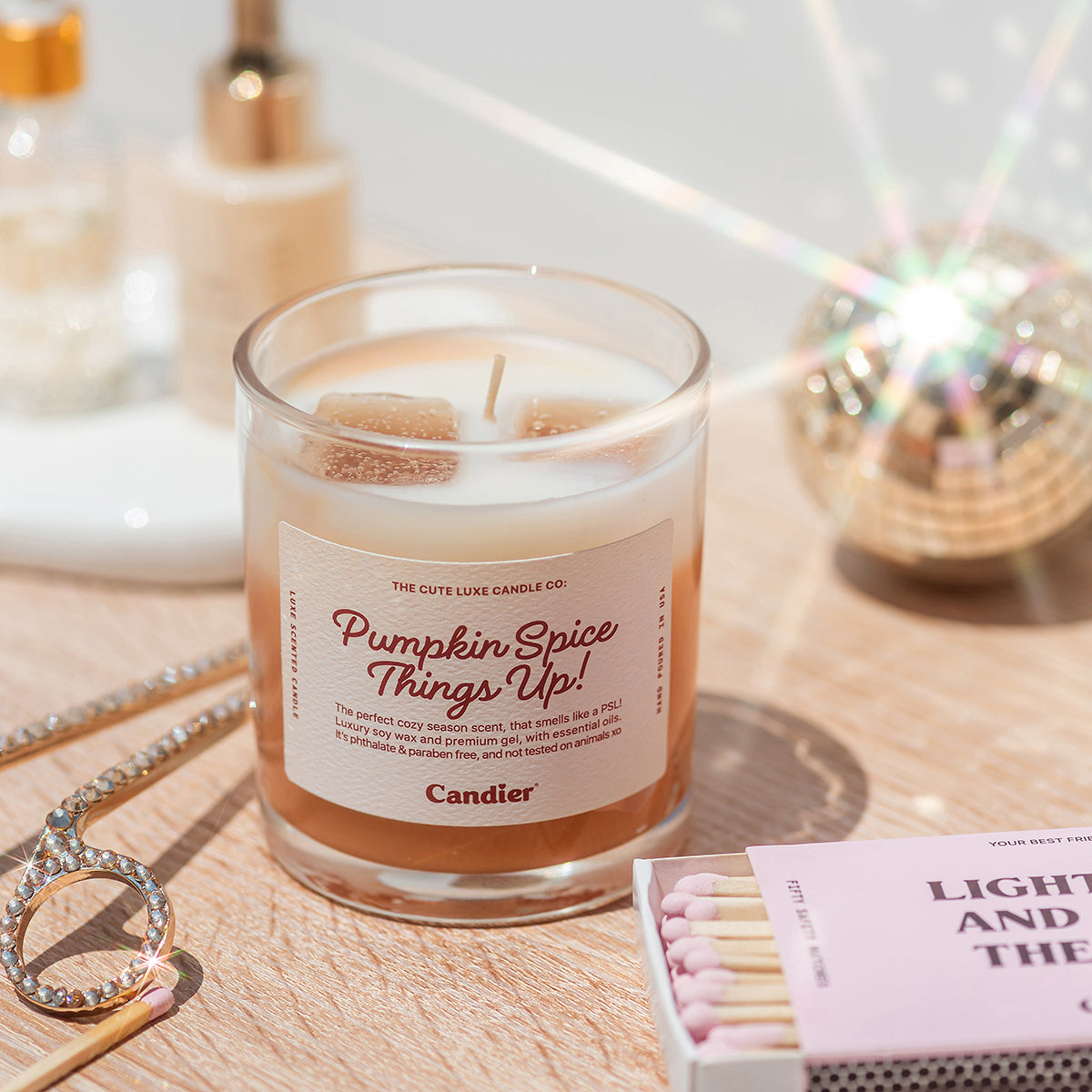 Bakery inspired Candier pumpkin spice candle styled with books and perfume, cute cozy candle gift for her or best gifts for teen girls.
