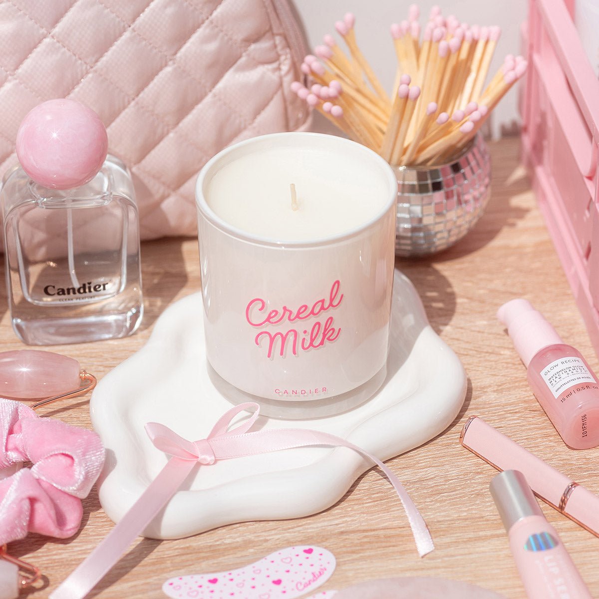 Candier Cereal Milk Candle styled with makeup and soft girl aesthetic decor. A fruit loops candle that makes a cute gift and dreamy cereal bowl candle.
