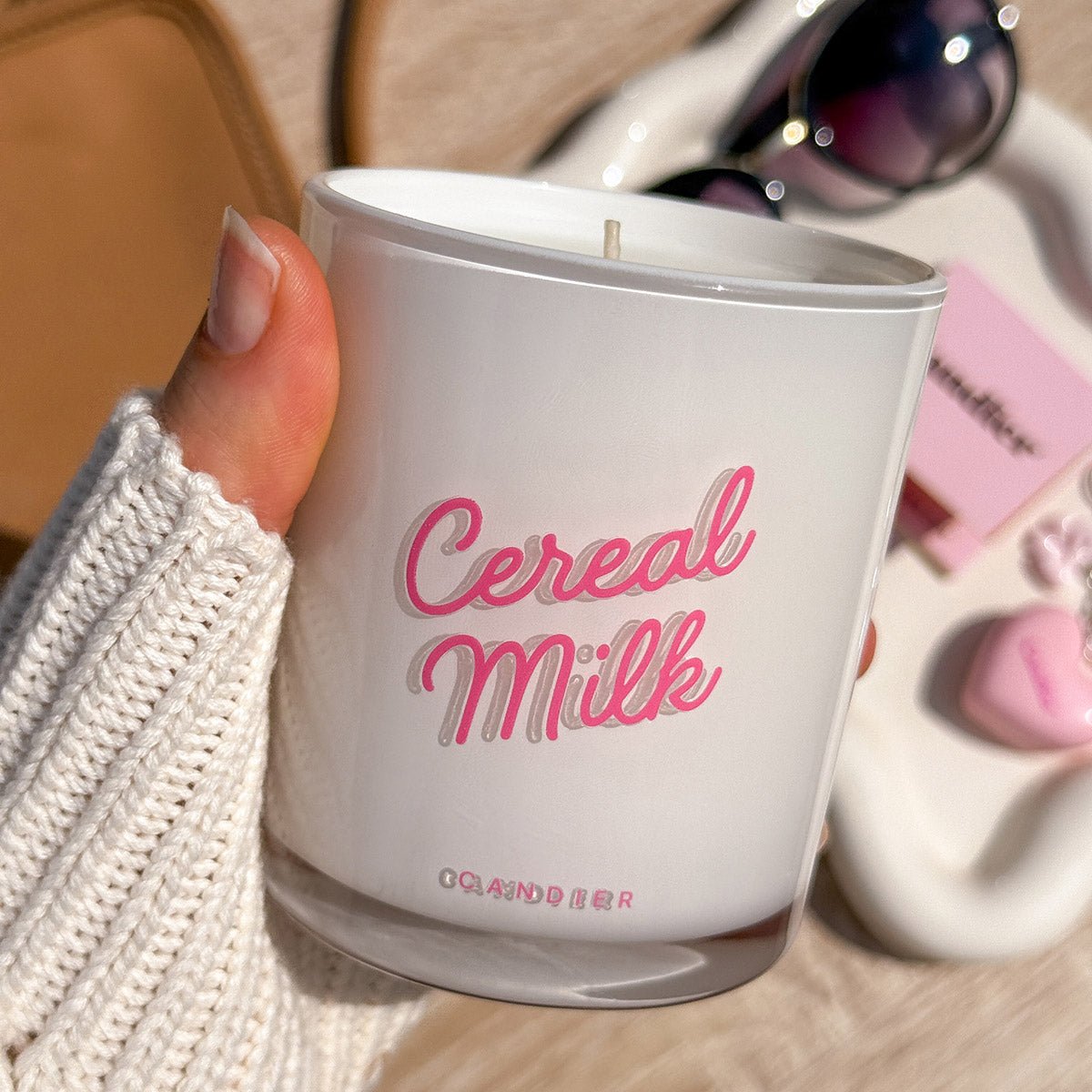 Candier Cereal Milk Candle held in hand, showing off a chic lux candle for sweet scented candles fans. A perfect cereal milk candle gift for her.
