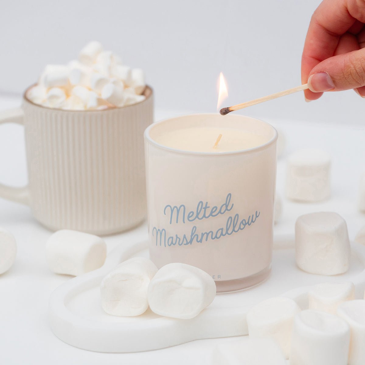 Cozy lifestyle scene featuring Melted Marshmallow â pretty candles with soft girl aesthetic sweetness; warm sweet scented candles.