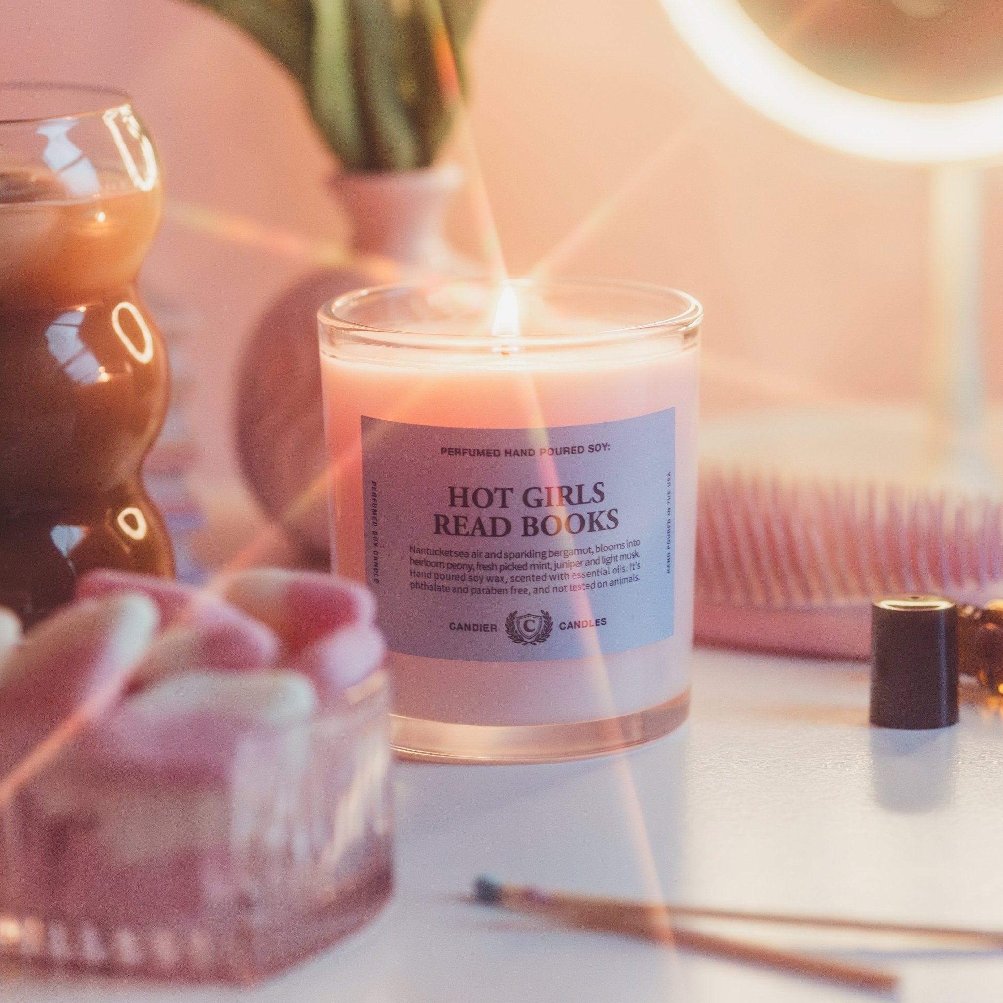 College girl holding Hot Girls Read Books candle, a unique college student gift for book lovers