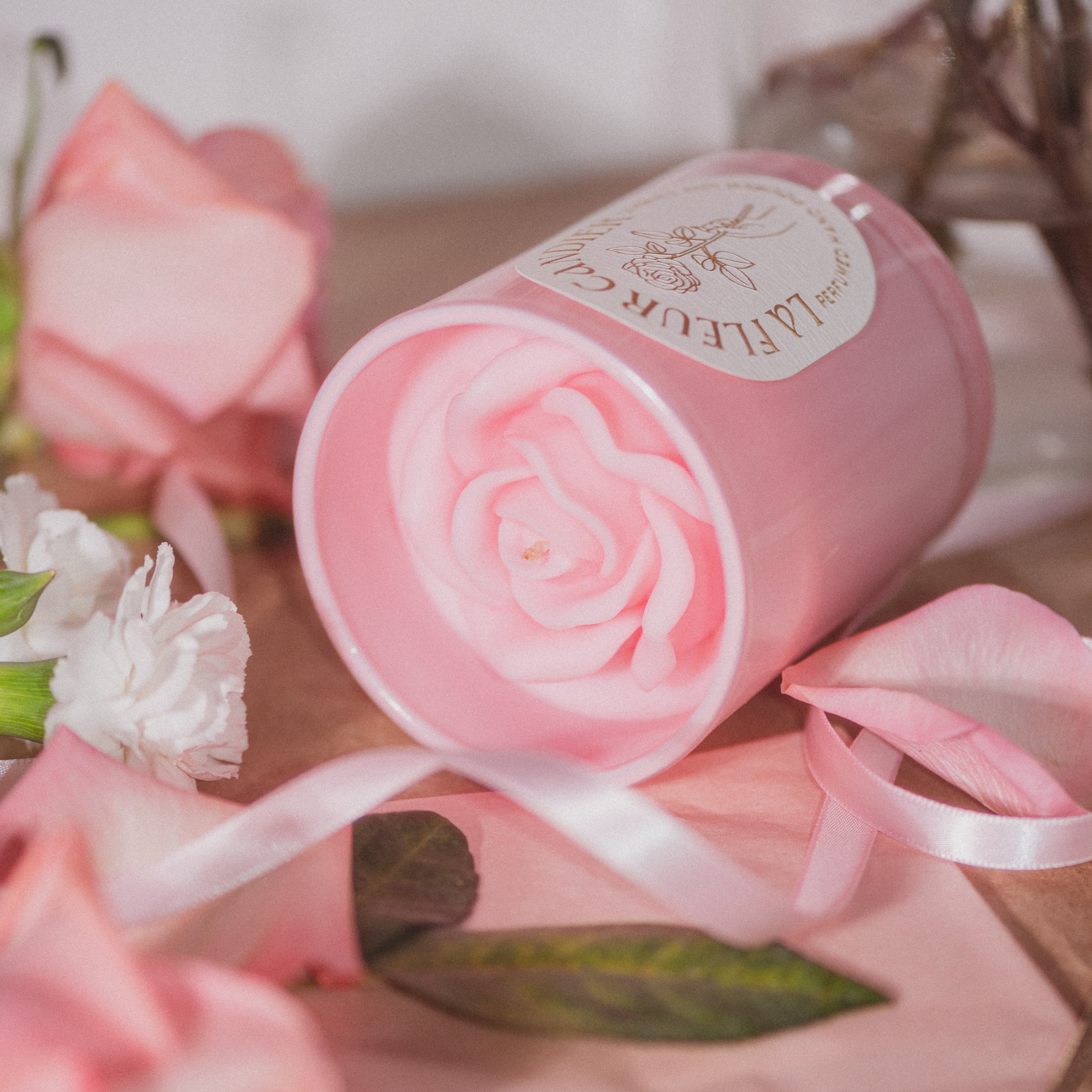 Pink flower candle styled with ribbon and florals, a cute candle with floral scents and romantic soft girl aesthetic decor