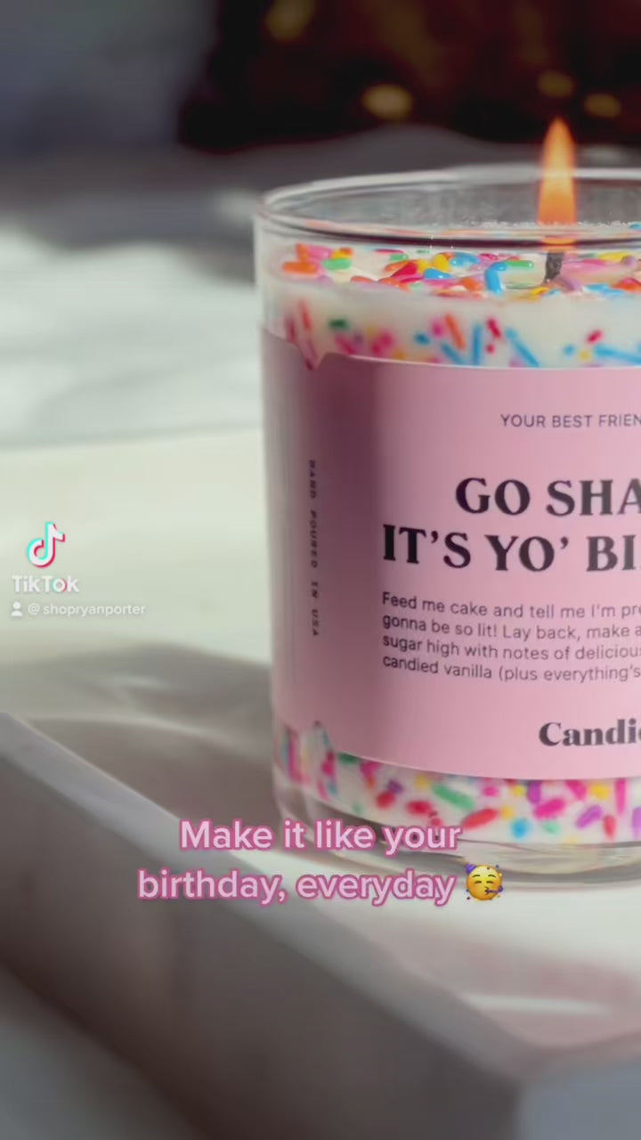 video of Cute birthday cake scented candle with colorful sprinkles being lit