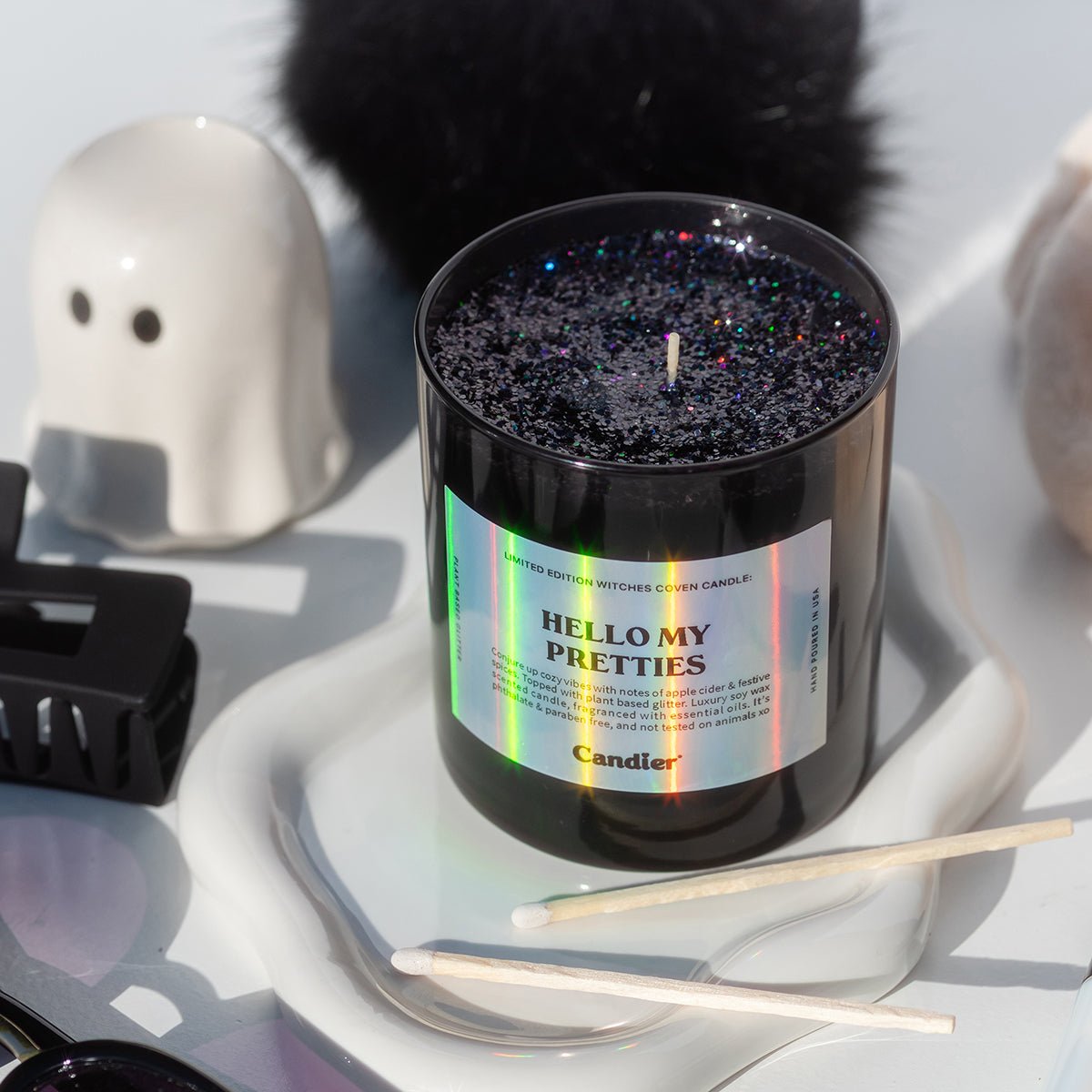 CandierĀ® Hello My Pretties candle styled in a dark glam flat lay, showing luxe aesthetic details and wicked Halloween energy, perfect for cute room decor and soft girl aesthetic setups.