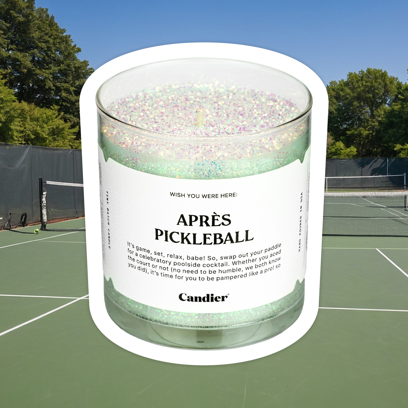 A sparkling green candle with plant based glitter and a label that reads Aprés Pickleball. fun pickleball gifts​