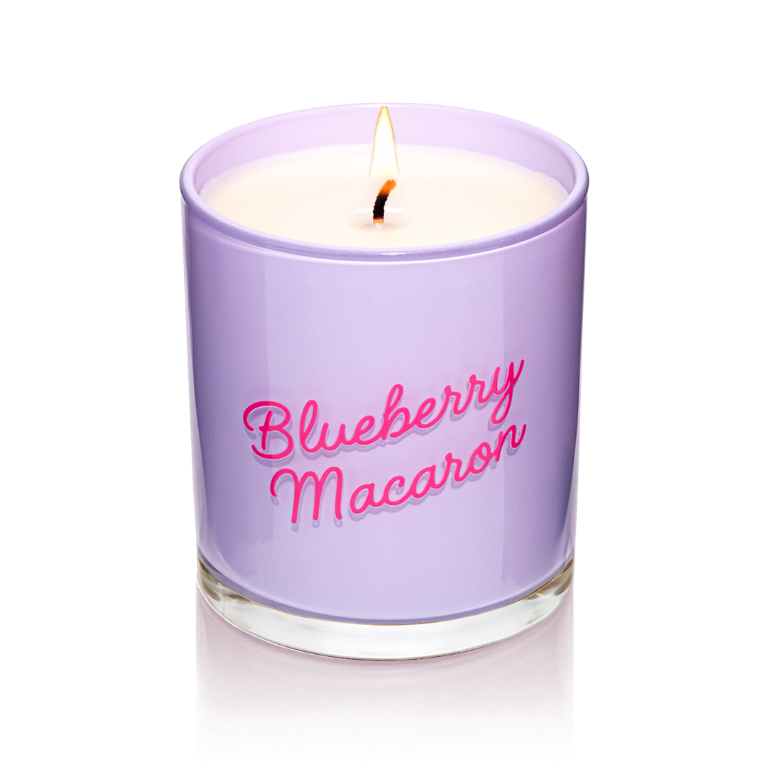 Blueberry Macaron candle in glossy lavender glass with red script. A luxury soy wax candle featuring dessert-inspired gourmand fragrance and vanilla notes.
