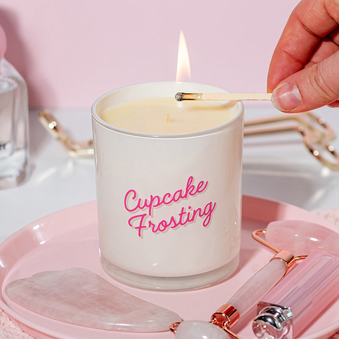 Candier Cupcake Frosting luxury candle on a pink soft girl aesthetic decor. Hand-poured vanilla bean dessert candle with cupcake frosting birthday cake fragrance notes, unique gift for women