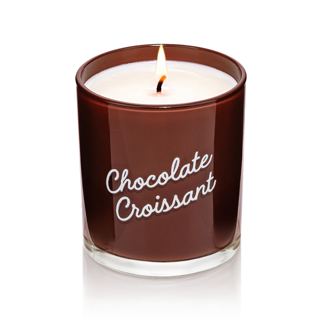 Candier Chocolate Croissant candle in glossy brown glass with white script. A dessert-scented soy wax candle featuring gourmand scent, chocolate, hazelnut, and vanilla fragrance.