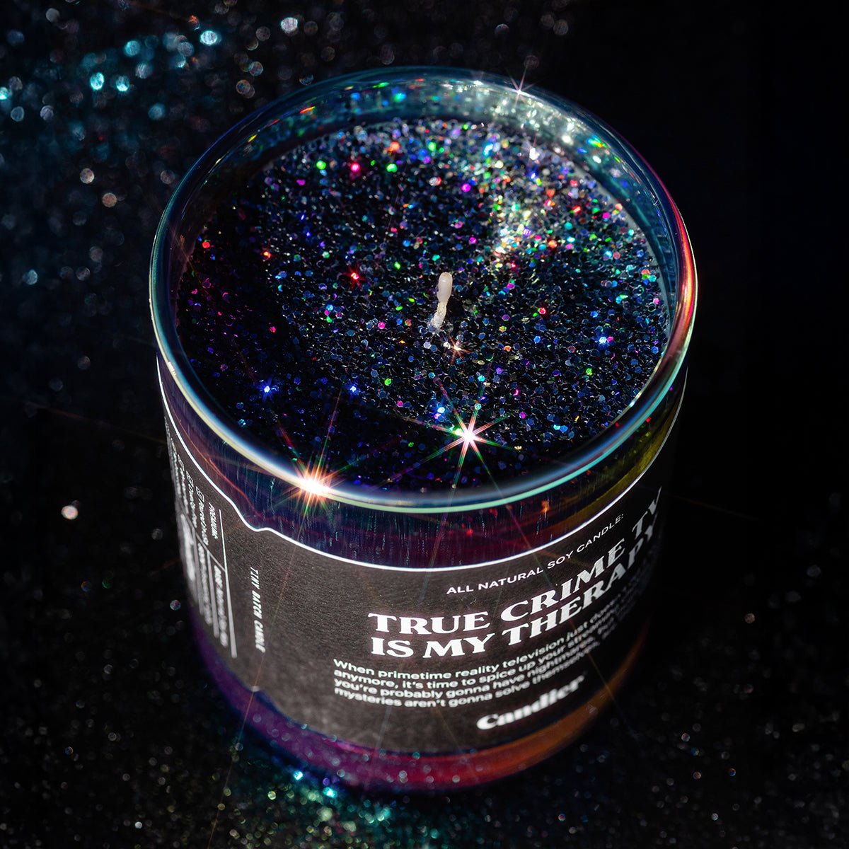 Sparkling plant based glitter candle by candier. True Crime TV themed with spicy spooky season scent 