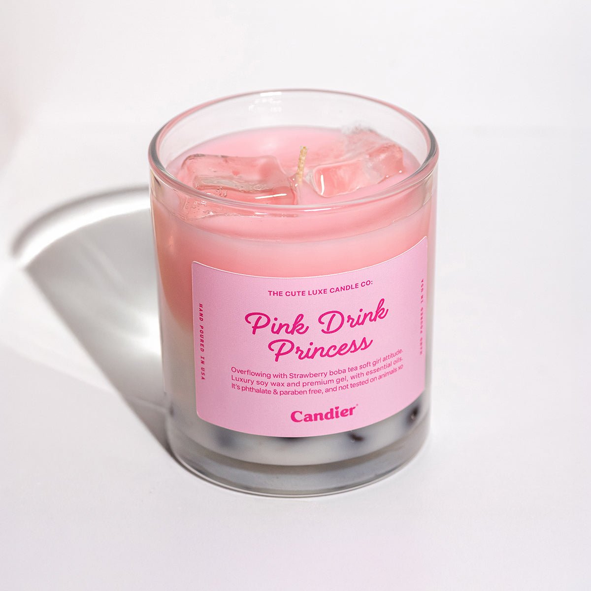 Cute pink candle labeled 'Pink Drink Princess strawberry boba latte' with soft girl aesthetic 
