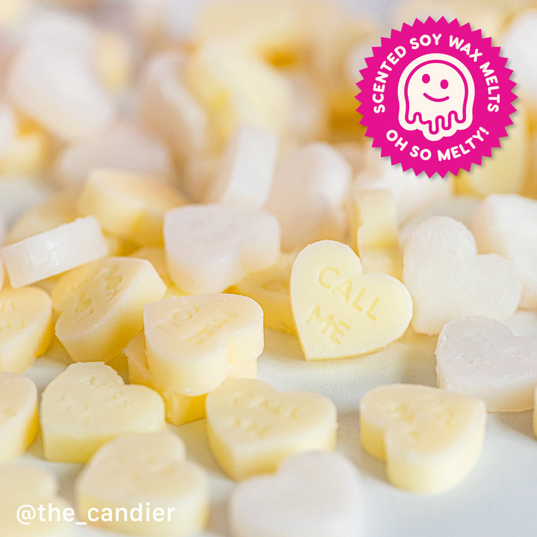 Candier Heart-shaped soy wax melts in soft white and yellow. Creates a tie-dye swirl effect when melted. Gourmand fragrance for cozy vibes with vanilla scent and cute candy heart inspired aesthetic.