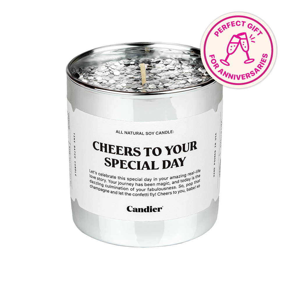 a silver candle with a label that reads Cheers to your special day and a barge that says perfect gift for anniversaries 