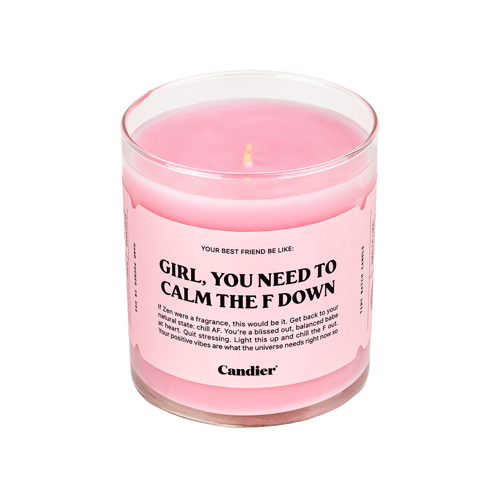 A hand lighting a pink candle with the text "GIRL, YOU NEED TO CALM THE F DOWN" on the label.