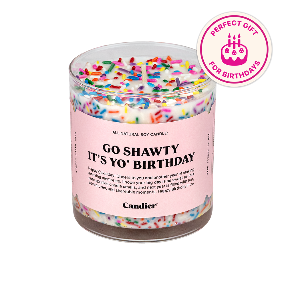 A birthday cake themed scented candle with colorful sprinkles
