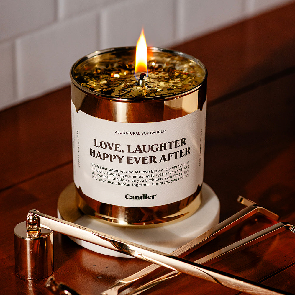 a gold candle with a label that reads Love, laughter, happy ever after 