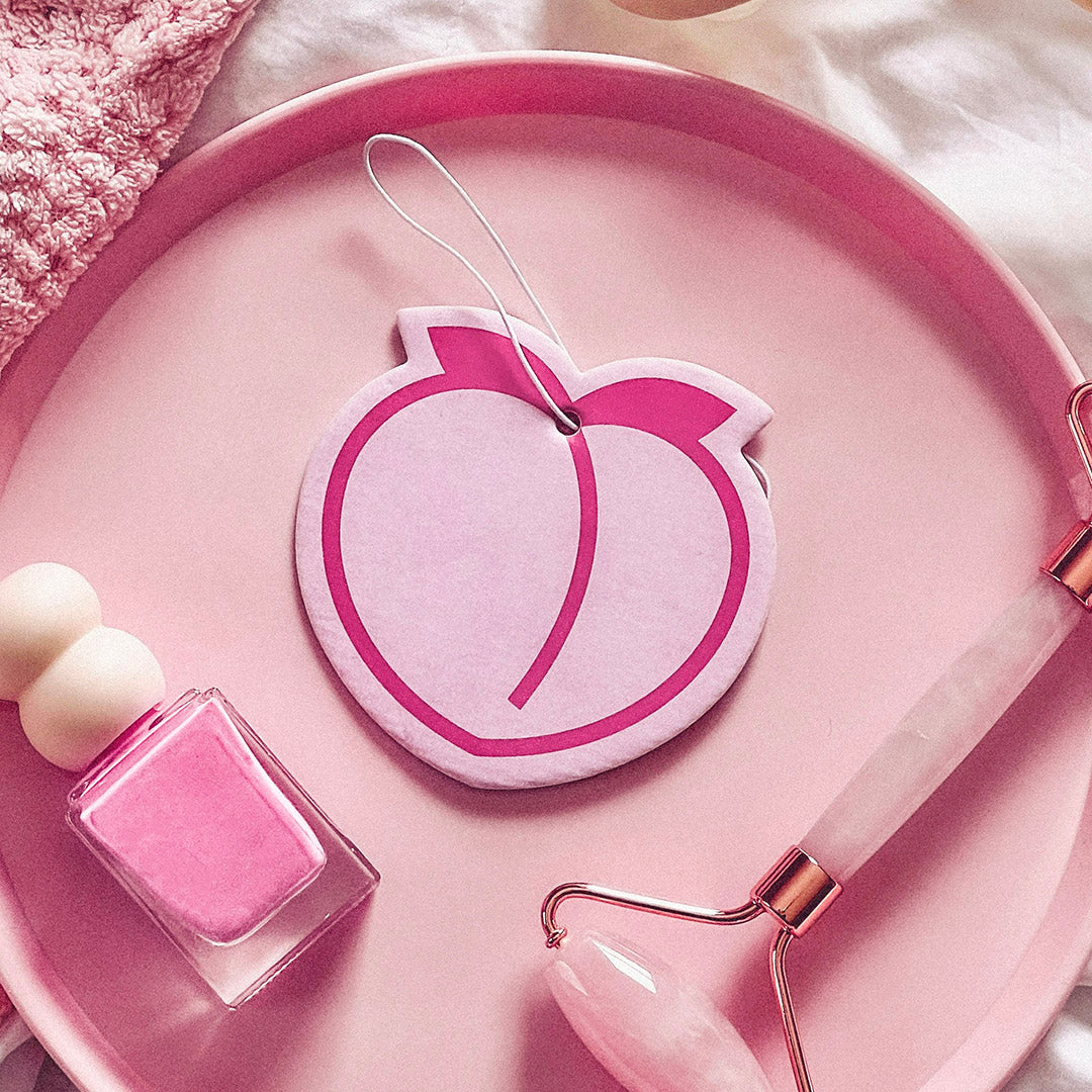 Aesthetic peach emoji air freshener. Adds fresh, fruity vibes to cars, makeup stations & bedrooms. A cute air freshener for home & beyond!