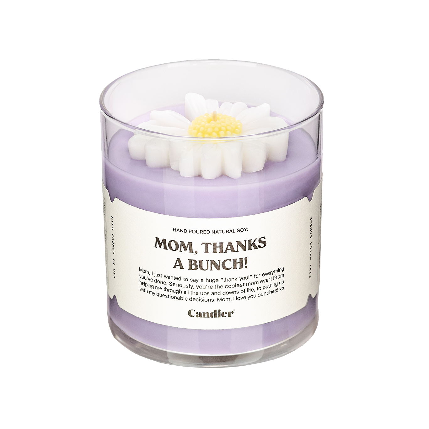 A purple candle with a sculpted wax flower on top and a label that reads Mom Thanks A Bunch