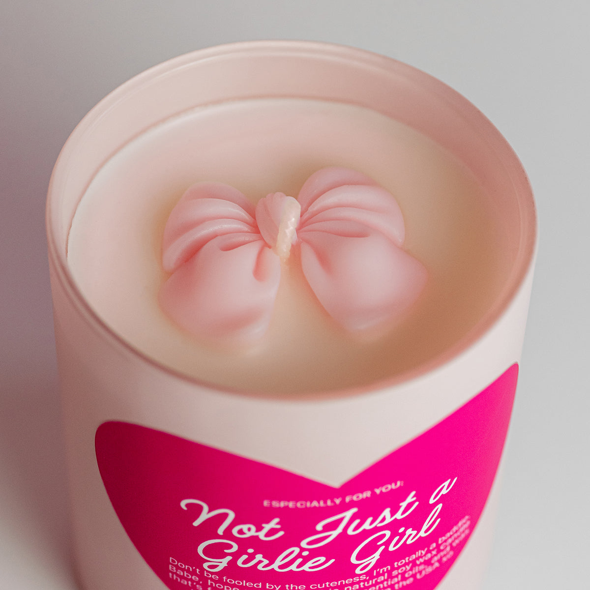 Blush pink aesthetic candle with a cute pink coquette bow, exuding clean girl vibes with peach, amber peony candle. A gorgeous birthday gift, Valentine’s treat, or luxe self-care must-have.