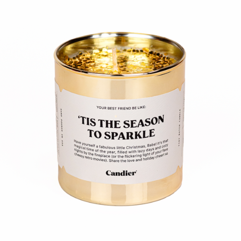 A Christmas themed Candier candle in a metallic gold glass vessel, topped with sparkling gold glitter and a label that reads "Tis The Season To Sparkle"