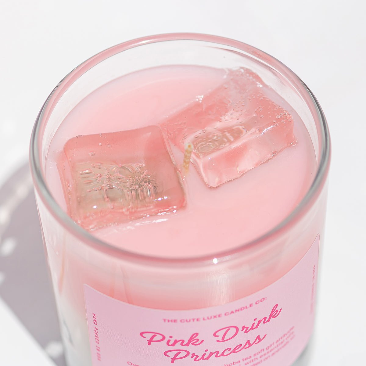 Strawberry candle with realistic gel ice cubes in a glass labeled 'Pink Drink Princess by Candier' 