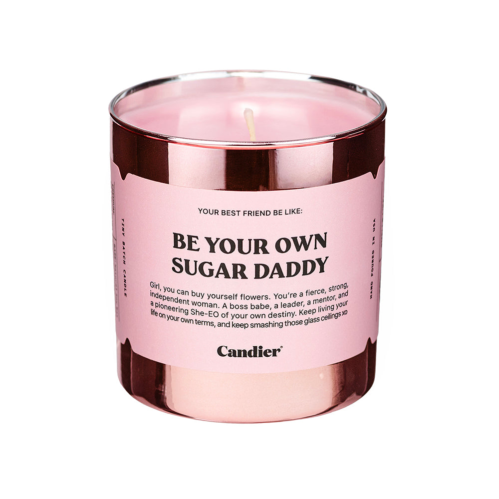 a pink and rose gold metallic candle with a label that reads Be Your Own Sugar Daddy
