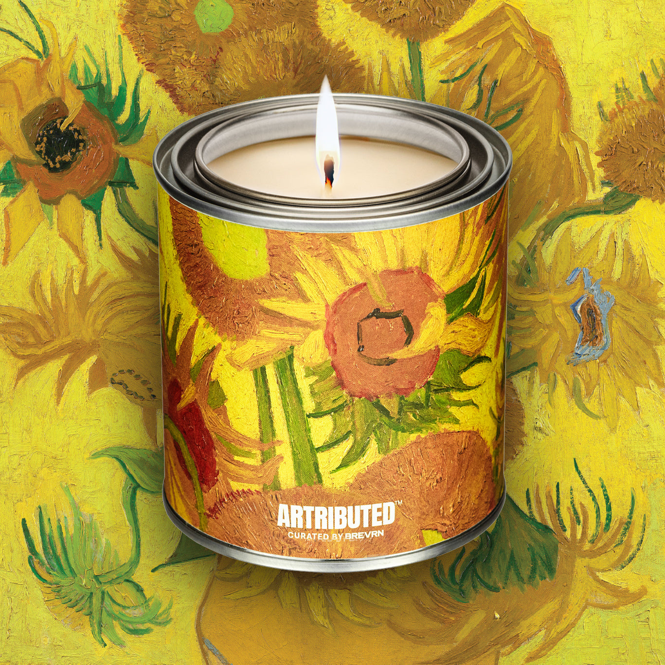 A lit fine art candle inspired by Vincent Van Gogh's Sunflowers, wrapped in a high quality reproduction of the famous painting. The background is also filled with the artwork