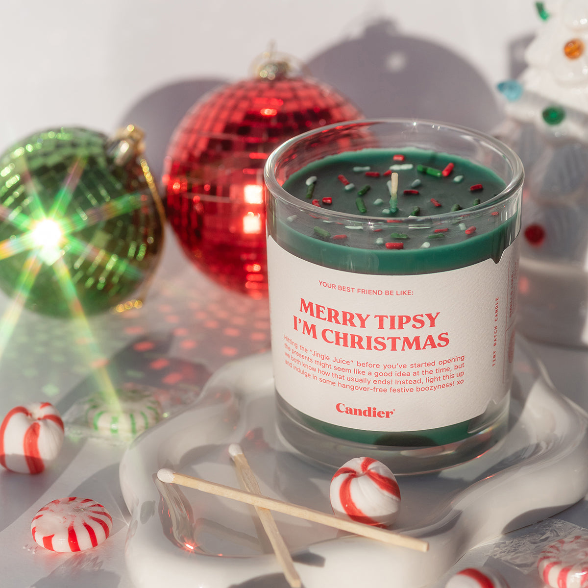 Holiday lifestyle with ornaments featuring Candier apple cinnamon candle — perfect white elephant gift ideas $50 and thoughtful Christmas gifts for sisters.