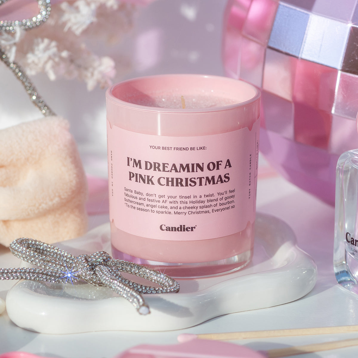 Pretty Candier candle in pink holiday setup — soft girl aesthetic Christmas candle for cute room decor and unique Christmas gifts for friends.